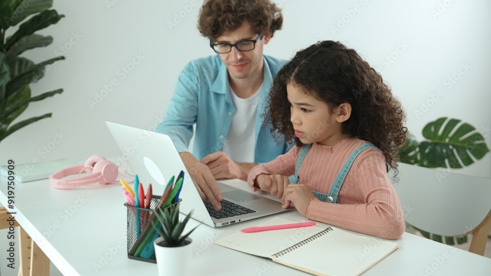 American daughter learning to coding and writing engineering prompt while positive smart father studying together and pointing at laptop screen to show programing code or system with care. Pedagogy. American daughter learning to coding and writing engineering prompt while positive smart father studying together and pointing at laptop screen to show programing code or system with care. Pedagogy.