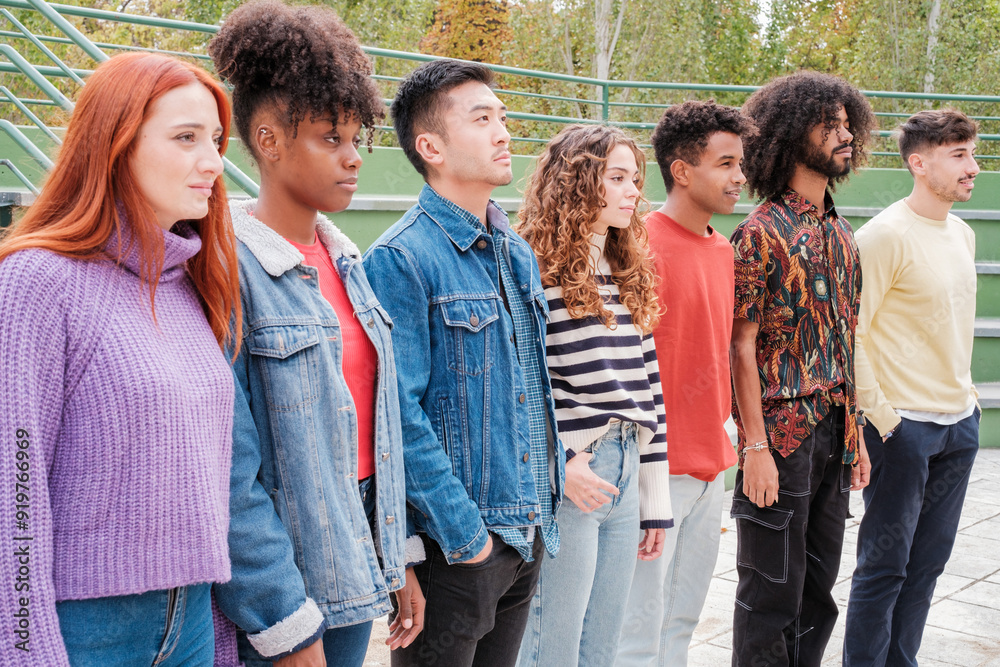 Group of young people of different origins in line to be chosen in an outdoor casting. Concept: choice Group of young people of different origins in line to be chosen in an outdoor casting. Concept: choice