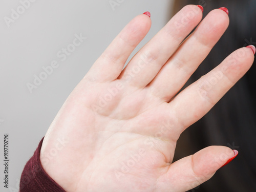 Woman showing stop hand sign gesture.