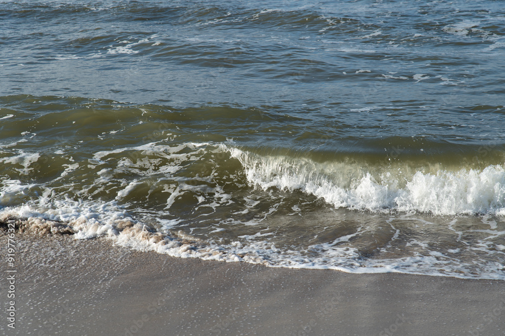 Surf on the Baltic Sea coast. Wave on a sandy beach. Surf on the Baltic Sea coast. Wave on a sandy beach.