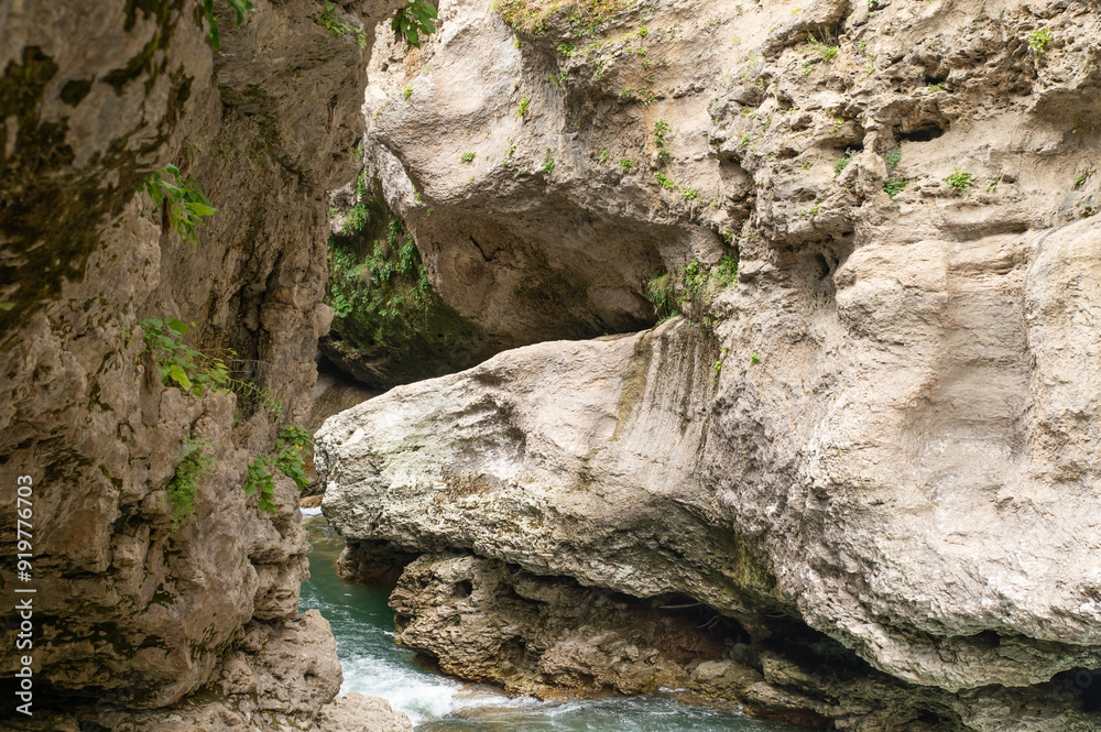 A stormy mountain river flowing in a narrow rocky gorge A stormy mountain river flowing in a narrow rocky gorge
