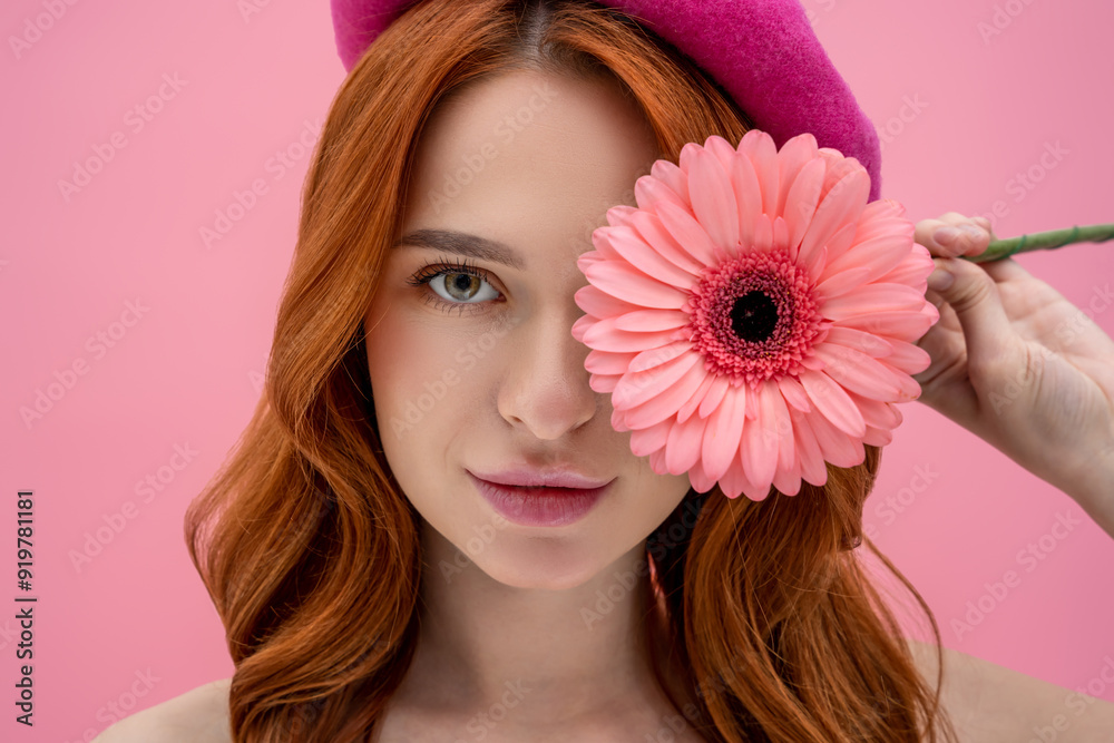 Portrait of a young beautiful ginger woman with a flower in hands Portrait of a young beautiful ginger woman with a flower in hands
