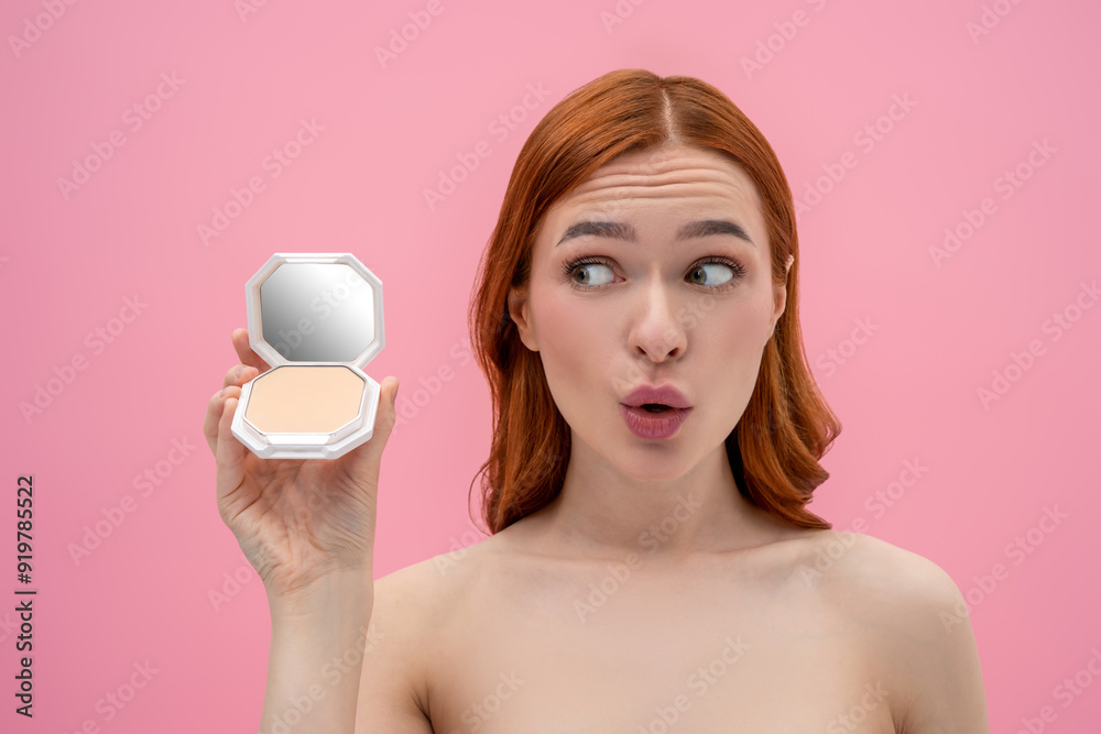 Ginger woman with bare shoulders with cream powder in hands Ginger woman with bare shoulders with cream powder in hands