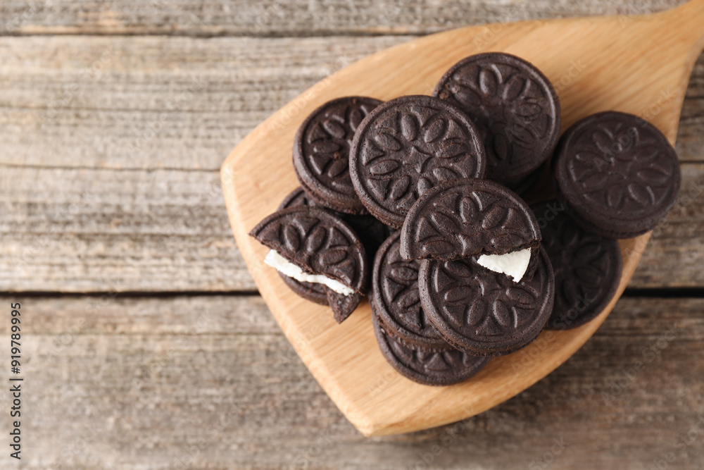 Many tasty sandwich cookies on wooden table, top view. Space for text Many tasty sandwich cookies on wooden table, top view. Space for text
