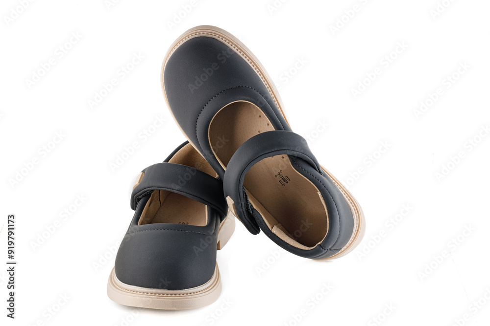 Cute child's black shoes, isolated on a white background. Full depth of field.