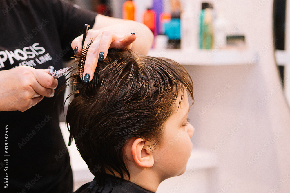 Naklejka premium A boy is sheared. dark hair. Short haircut 