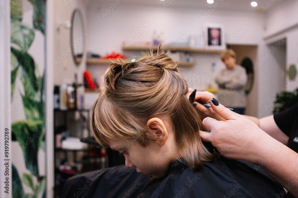 They cut the girl's hair. Bangs are cut They cut the girl's hair. Bangs are cut