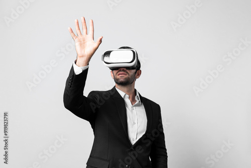 Professional smart business man holding something while wearing VR glasses. Caucasian project manager with virtual reality goggles while present technology innovation with blue background. Deviation.