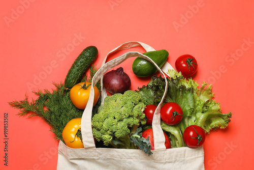 Fototapeta Naklejka Na Ścianę i Meble -  Delivery of vegetarian products. Bag with different vegetables and fruits on red background, top view