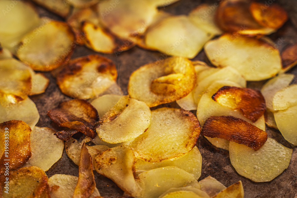 Potatoes fried in a pan until golden brown. Fried potato slices in a steel pan. Quick homemade vegetarian dish Potatoes fried in a pan until golden brown. Fried potato slices in a steel pan. Quick homemade vegetarian dish