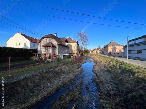 Olesná river flowing through the center of Palkovice village photo