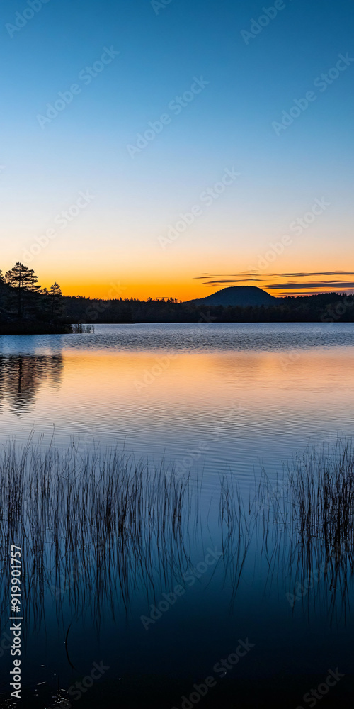 Fototapeta premium Calmness illustrated by a serene lake at sunset