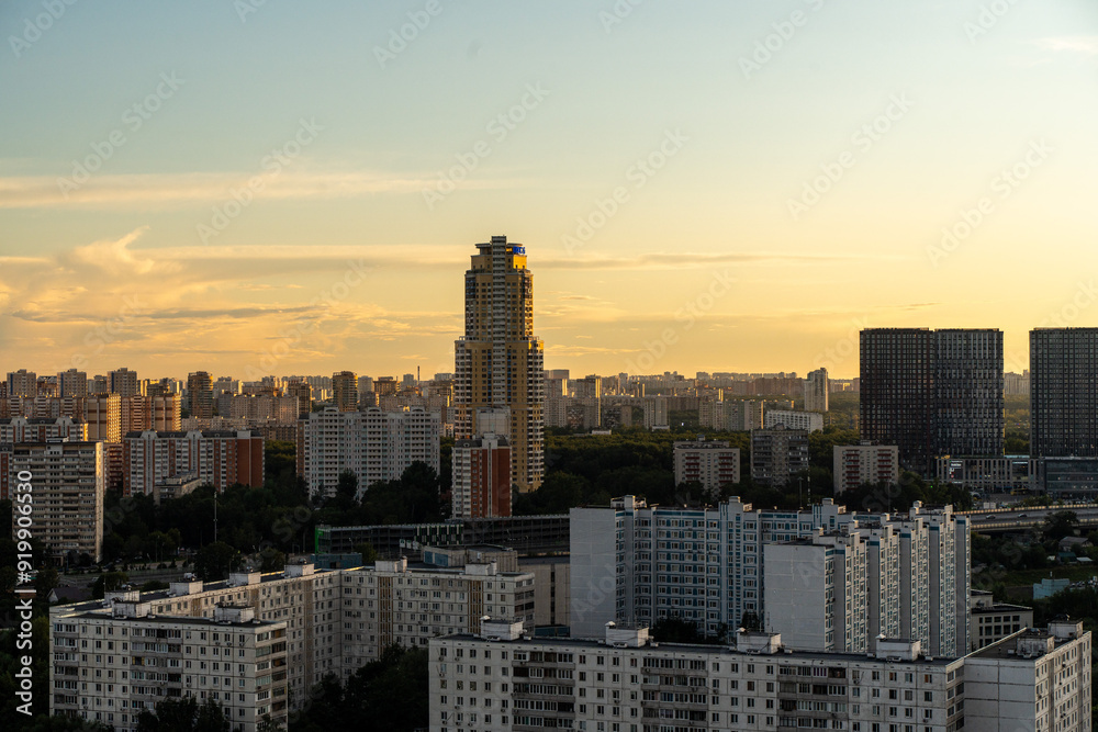Fototapeta premium Moscow, Russia, August 12, 2024: A big city at sunset, a panorama of multi-storey residential buildings. Moscow, Zapadnoye Degunino. High quality photo