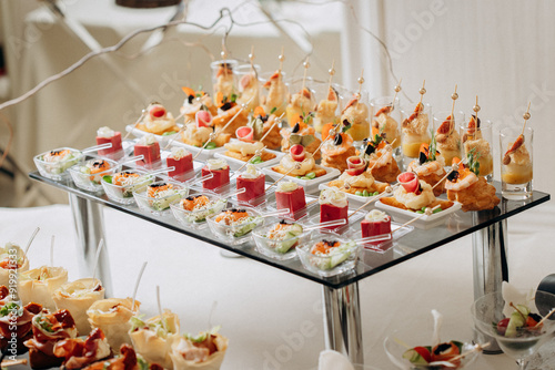 Assortment of delicious snacks on the open buffet festive table in restaurant. Catering plate