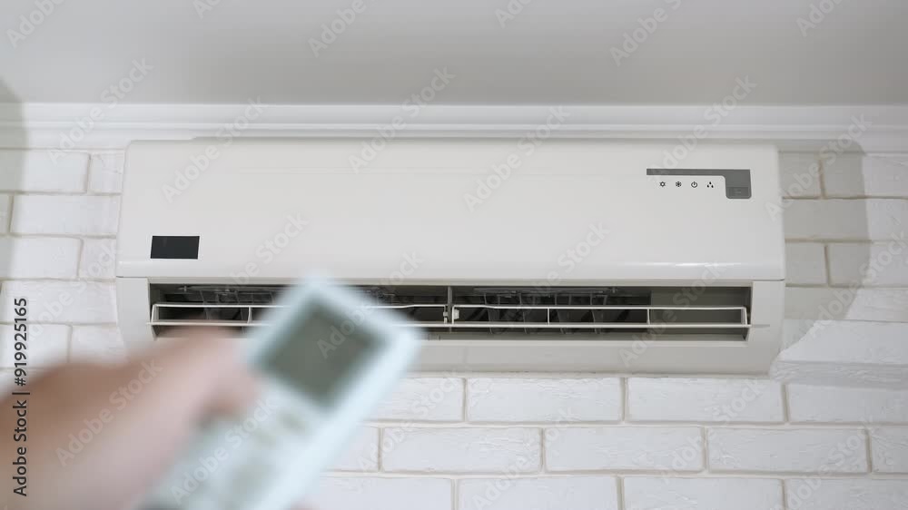 Man hand switch off the air cooling system. A man hand switch the air conditioner to change the temperature in his apartment.