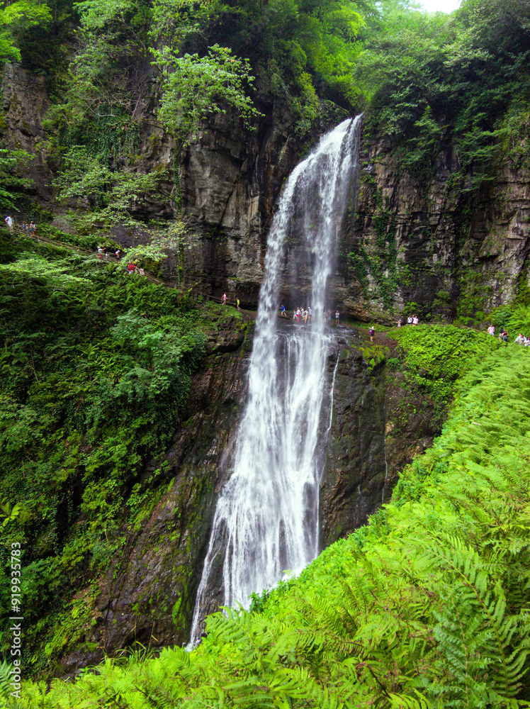 Waterfall the Giant or Velikan in Abkhazia, great spring in mountain in summer. Concept of forest, water, nature, landscape, travel Waterfall the Giant or Velikan in Abkhazia, great spring in mountain in summer. Concept of forest, water, nature, landscape, travel