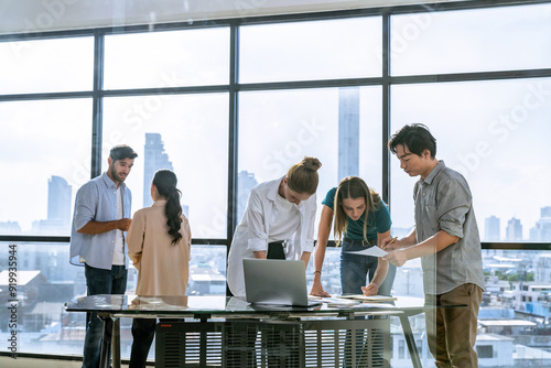 Skilled multicultural businesspeople in casual outfit working together. Professional manager brainstorming, sharing, planing marketing strategy. Business team presented strategy to investor. Tracery.