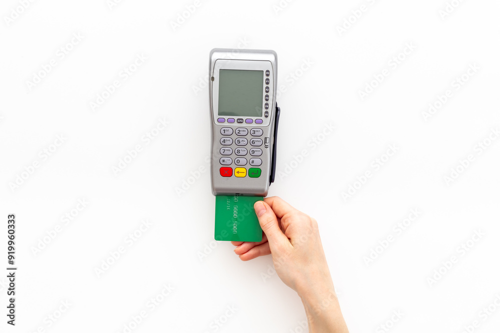 Female holding in hands bank payment terminal for contactless payment by credit cards, top view Female holding in hands bank payment terminal for contactless payment by credit cards, top view