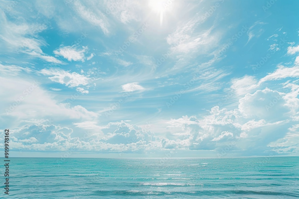 Obraz premium A person surfing in the ocean, with waves and sun