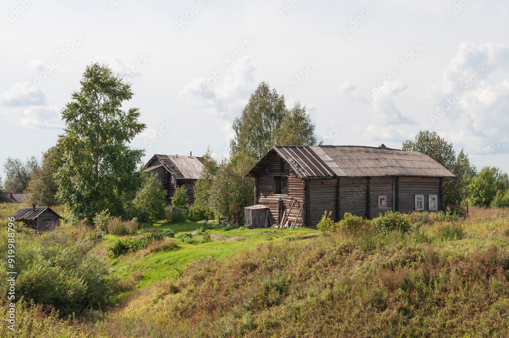 Old country log houses in northern russian village, summer day Old country log houses in northern russian village, summer day