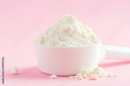 White Protein Powder Scoop on Soft Pink Background photo