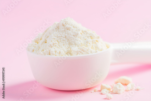 White Protein Powder Scoop on Soft Pink Background photo