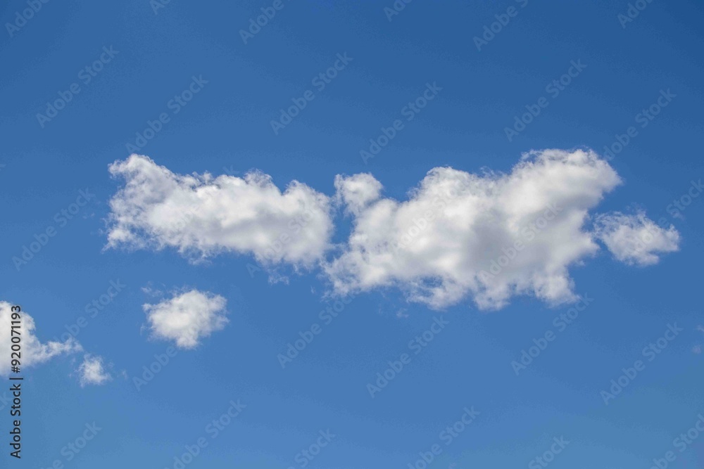 White clouds fly over with blue skies behind White clouds fly over with blue skies behind