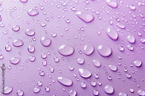 Water drops on purple background. Rain drops on glossy window glass.