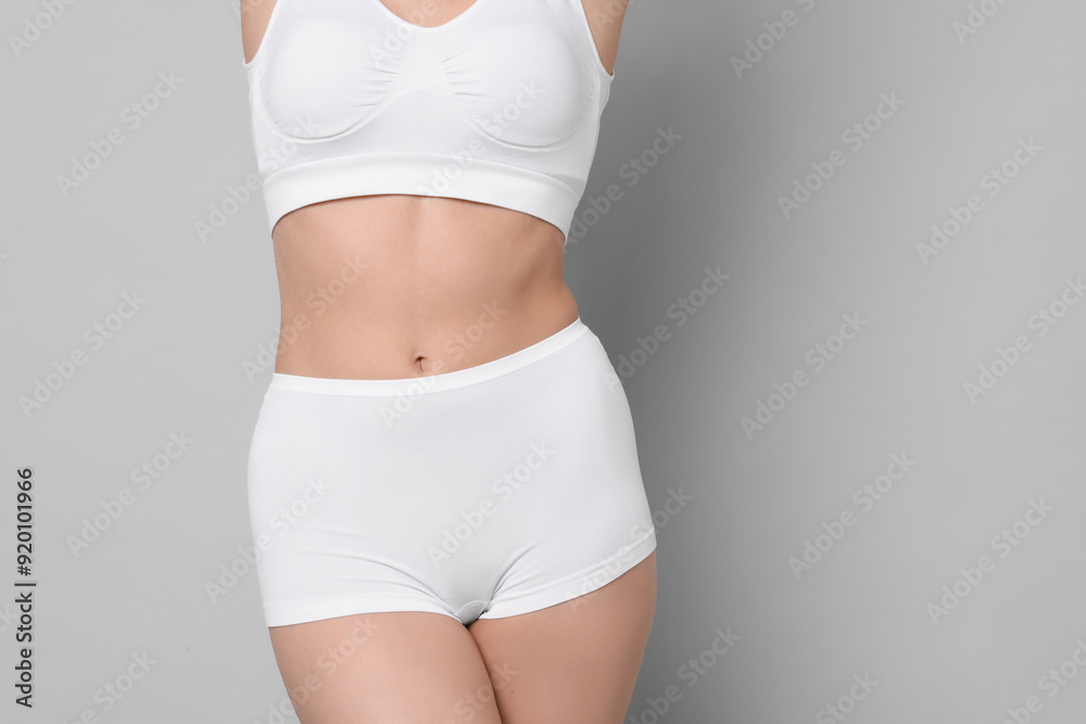 Fototapeta premium Diet and weight loss concept. Woman with slim body against light grey background, closeup. Space for text