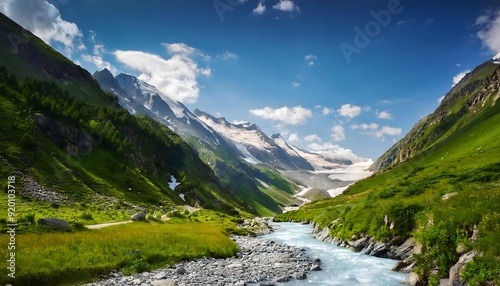 A beautiful mountain valley with river and blue sky. Wallpaper