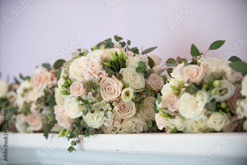 Pink pastel and white roses bridal bouquets lined up on fire place mantle