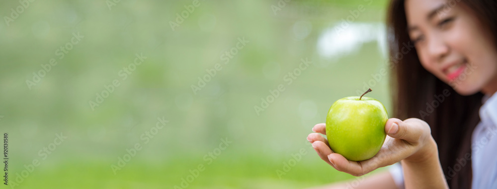 Banner young asian woman bite green Apple Healthy. Girl workout holding organic apple fruit healthy lifestyle. Banner close up women hands holding green apple. Women dieting lifestyle with copy space Banner young asian woman bite green Apple Healthy. Girl workout holding organic apple fruit healthy lifestyle. Banner close up women hands holding green apple. Women dieting lifestyle with copy space
