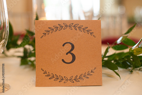 Brown table sign centerpiece with black  letters that reads 