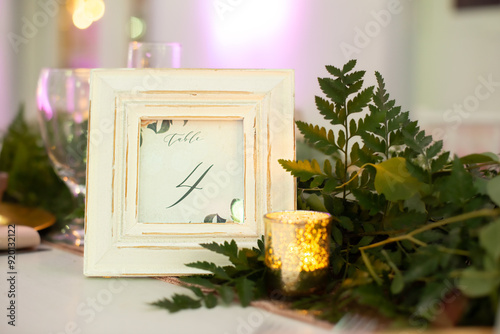 Rustic white picture frame table sign centerpiece with black letters that read 