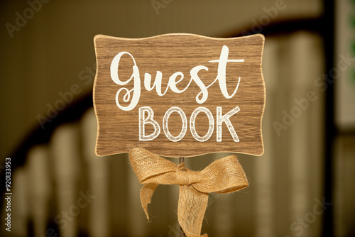 Elegant wood sign with a canvass bow that reads