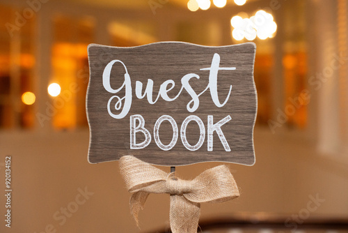 Elegant wood sign with a canvass bow that reads