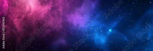 A beautiful cosmic nebula is showcasing vibrant hues of pink, blue, and purple within the vast depths of space