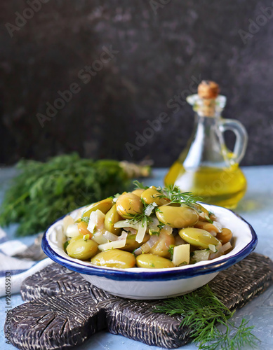 A traditional Aegean appetizer, fresh broad bean salad is prepared with olive oil, broad beans, onion, and dill	 photo