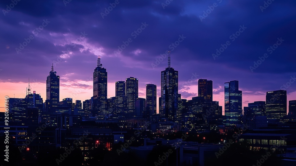 Fototapeta premium Stunning City Skyline at Dusk with Dramatic Purple Clouds