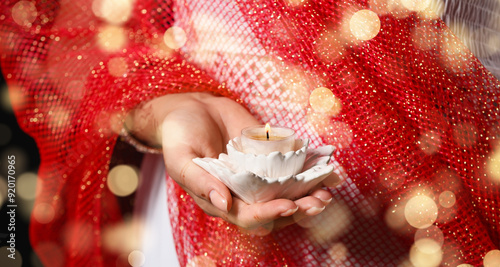 Woman holding burning candl...