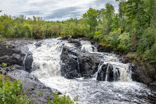 Majestic Kawishiwi Falls Cascading Through Lush Wilderness near Ely, Minnesota - A Serene Landscape of Flowing Waters and Rugged Rocks photo