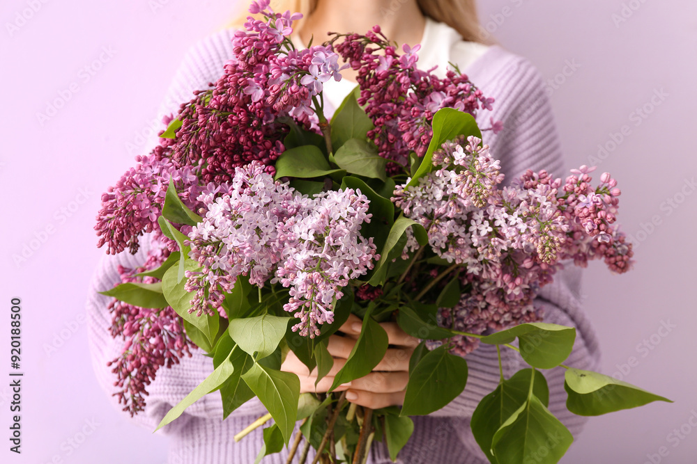 Woman holding bouquet of lilacs on color background Woman holding bouquet of lilacs on color background