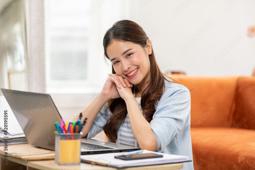 beautiful asian young woman wear casual sit on couch using computer laptop entertain with social media relax smile and laughing.Freelance woman working online sale marketing. Shopping online at home beautiful asian young woman wear casual sit on couch using computer laptop entertain with social media relax smile and laughing.Freelance woman working online sale marketing. Shopping online at home