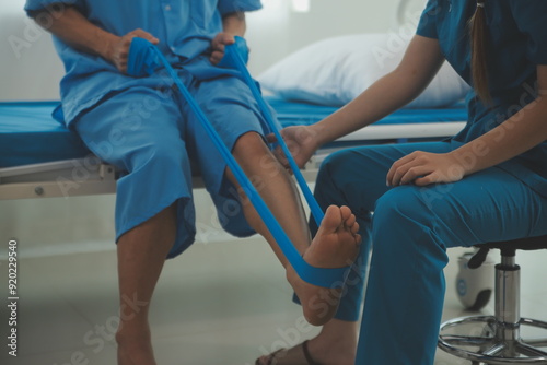 Physical therapists work with patients in close-up clinics. The concept of rehabilitation of physical health, the doctor gives advice to the patient. Ankle problems and muscle injuries