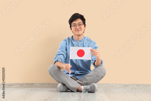 Young Asian man with flag o...