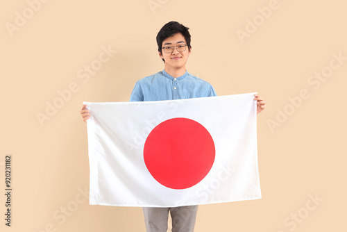 Young Asian man with flag o...