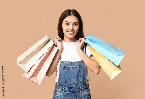 Happy young woman holding c...