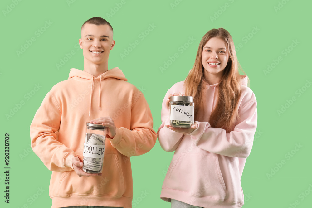 Young students with jar banks on green background. Concept of savings for education Young students with jar banks on green background. Concept of savings for education