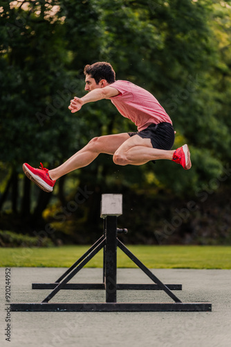 Obraz na plátně Steeplechase runner training on the athletics track. Vertical