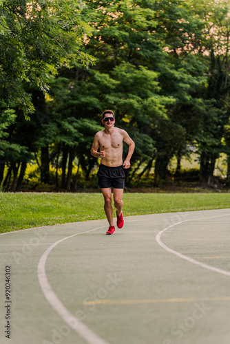 Expert athlete having a good time running on the outdoor running track